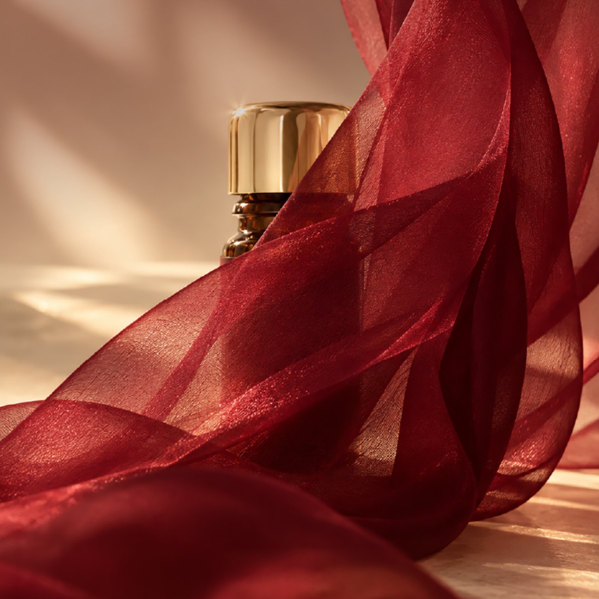 LIBERTY Body Essence üvegcse vörös selyem mögött, meleg napfényben